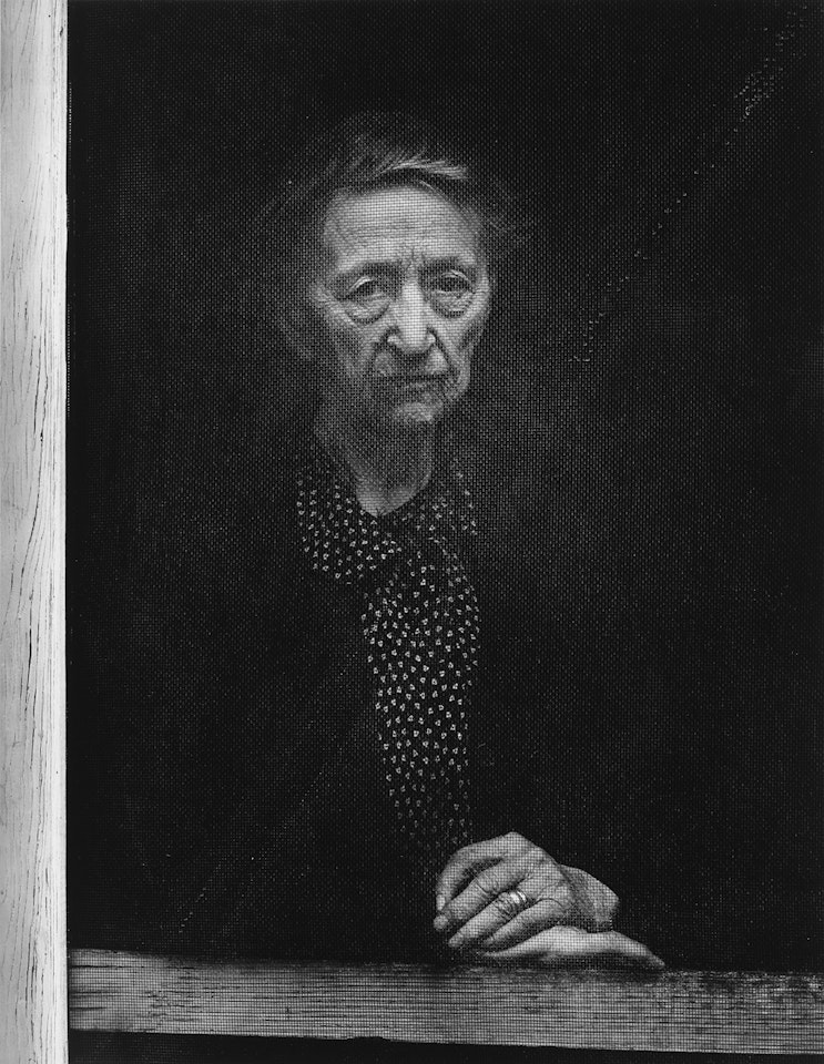 Woman Behind Screen Door, Independence, California by Ansel Adams