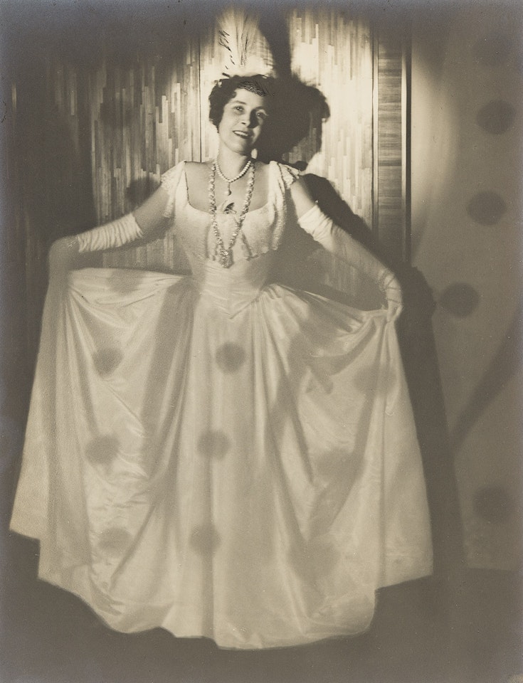 Woman holding skirts wide by Man Ray