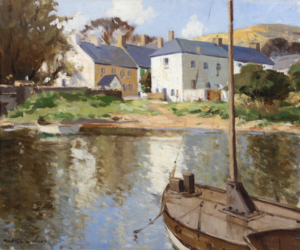 A Riverside Village with Moored Boats by Maurice Canning Wilks