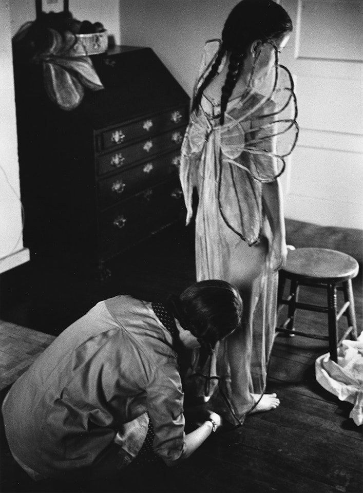 Child wearing angel wings by André Kertész
