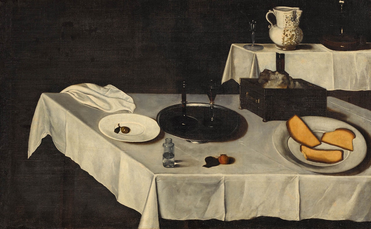 Two draped tables laden with an array of objects including wine glasses, a silver dish, a silver casket, a painted water jug and an apricot by Spanish School