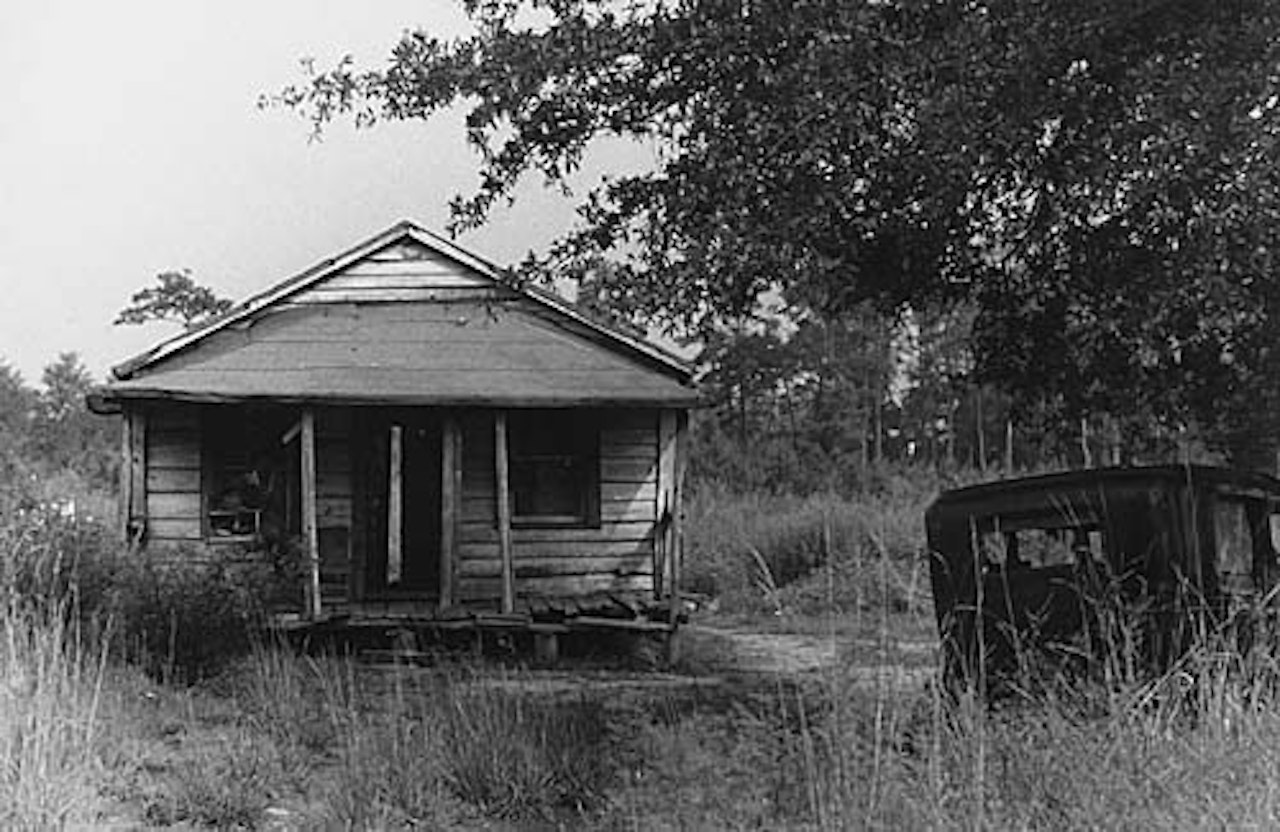 Untitled (dilapidated shack and car) by Robert Frank