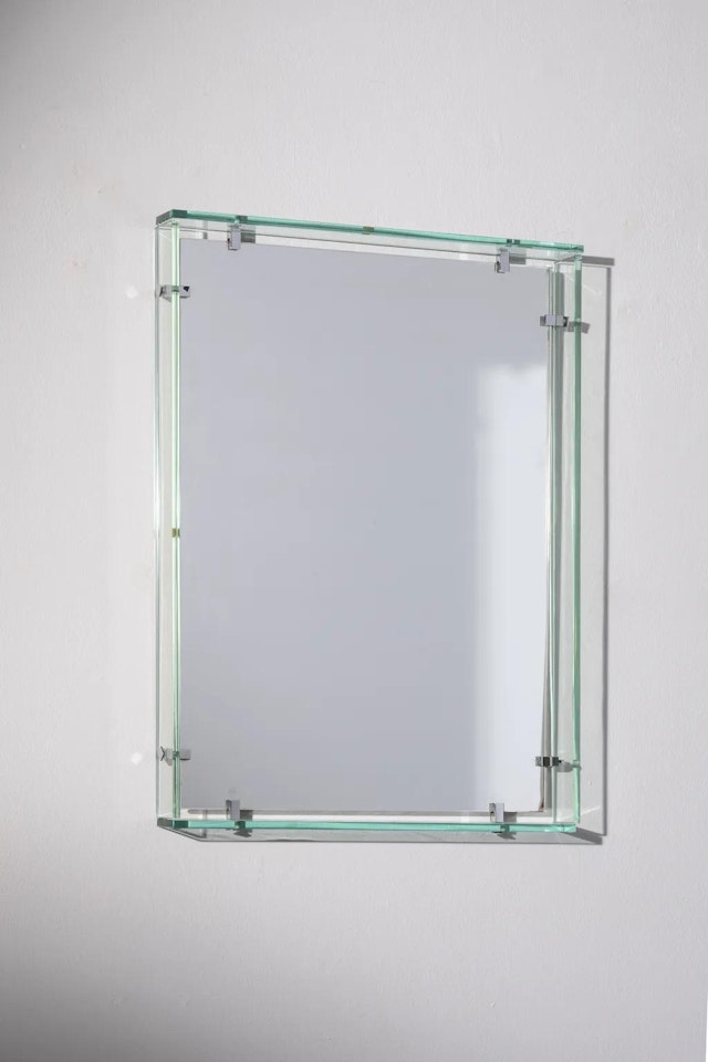A glass and chromed metal mirror by Max Ingrand