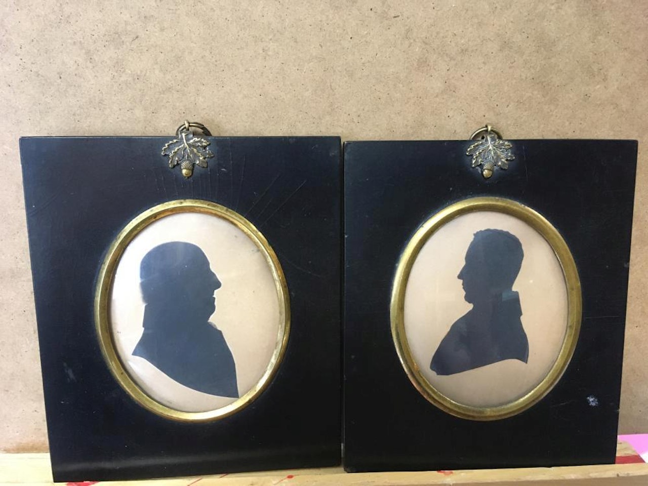 silhouette portraits of a lady and gentleman; a Portrait miniature of a gentleman in black coat and white stock by English School