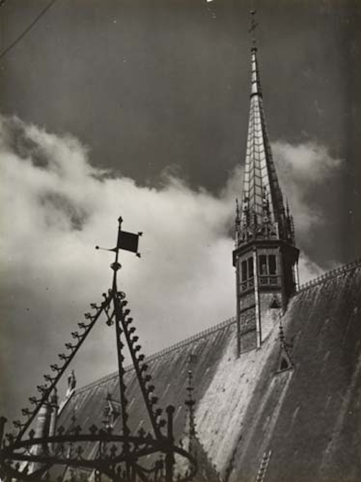 Church spire and weather vane. by André Kertész
